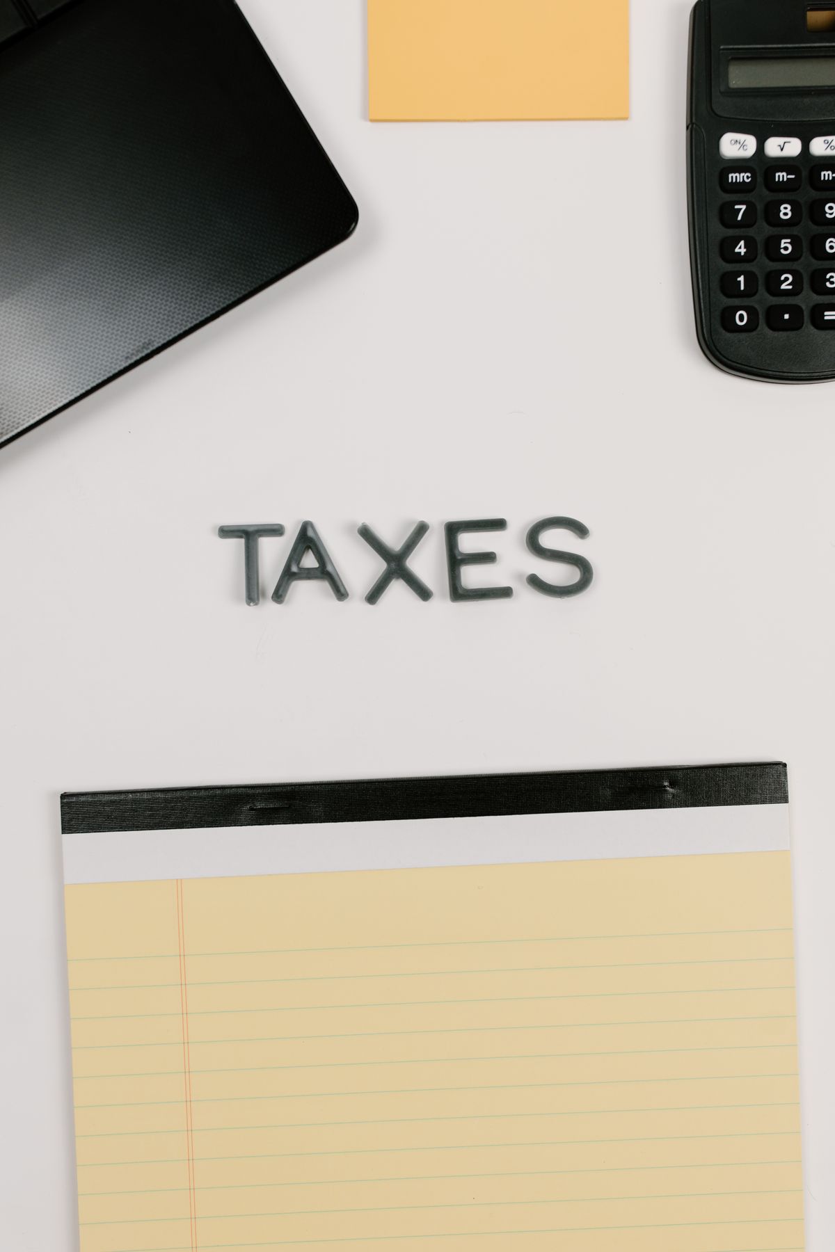 Accountant reviewing financial statements and tax documents at a desk with a calculator