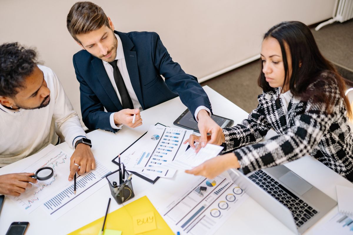 Consultants reviewing a business plan and financial projections during a strategy meeting
