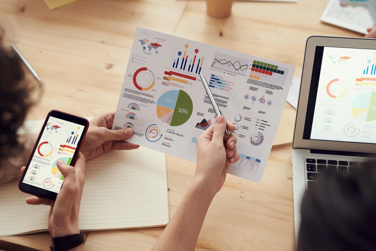 Analyst reviewing market research data and charts during a study