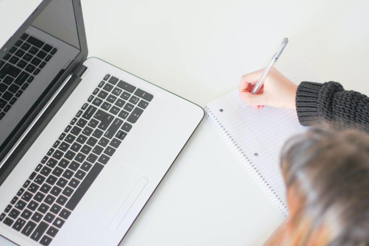Writer working on marketing copy and content strategy documents on a laptop