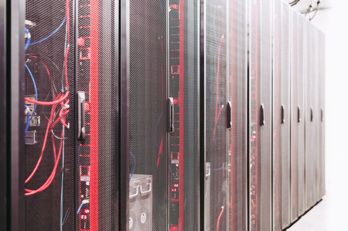 Server room with networking racks representing IT infrastructure setup and support